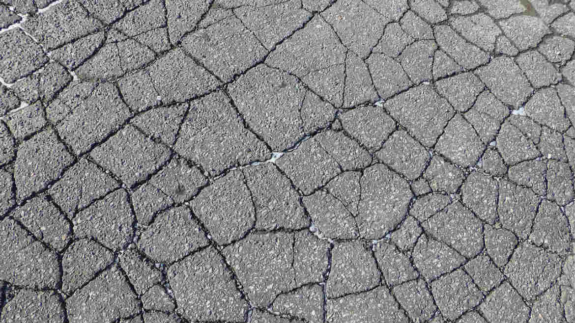 Cracked Asphalt Parking Lot - Asphalt Repair Solutions